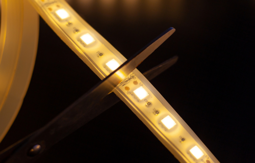 Scissors cutting LED Strip at specific cut markings